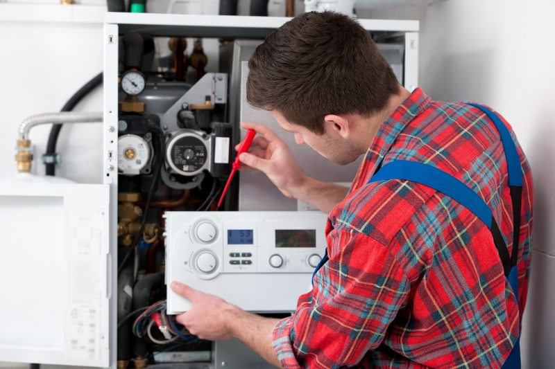 Gas Safe engineer working on a boiler in Worcester Park
